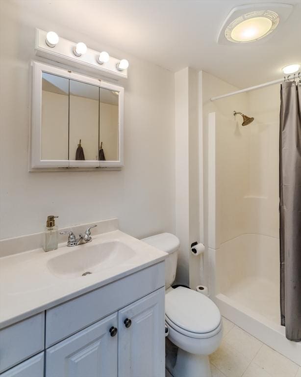 bathroom with toilet, a stall shower, tile patterned flooring, and vanity