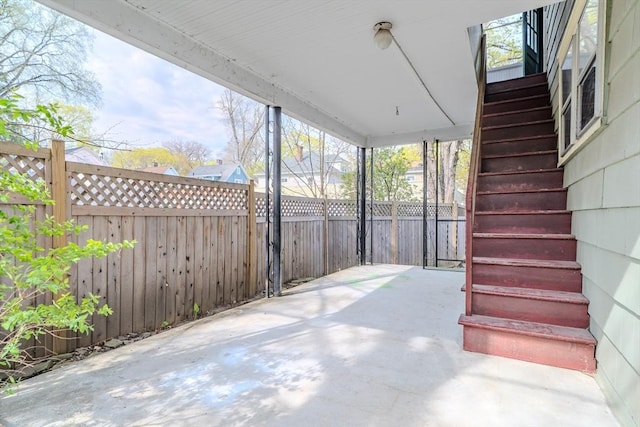 view of patio / terrace with fence and stairway