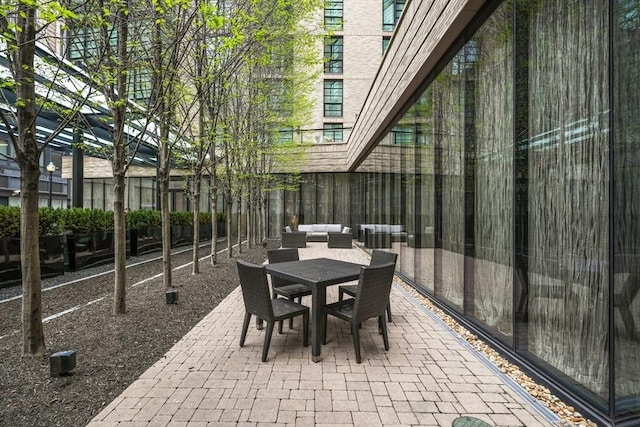 580 Washington St Unit 411, Boston, MA 02111 - view of patio featuring outdoor dining area and fence