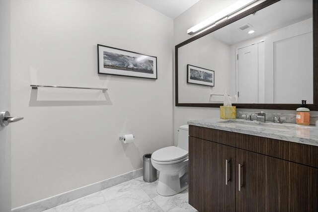 580 Washington St Unit 411, Boston, MA 02111 - half bathroom featuring marble finish floor, visible vents, toilet, vanity, and baseboards