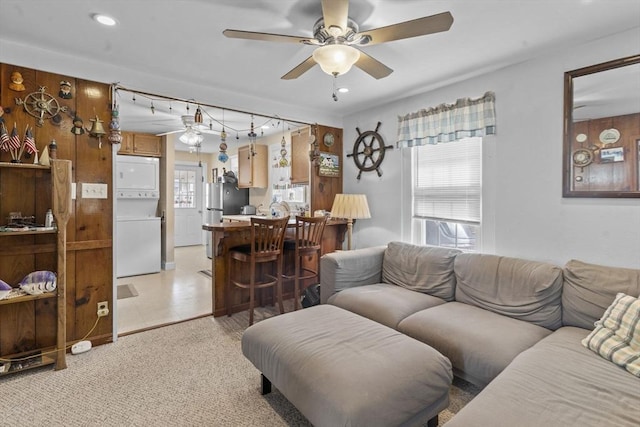 living room featuring recessed lighting, a healthy amount of sunlight, a ceiling fan, and stacked washing maching and dryer