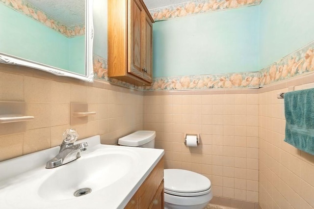 116 Corey Colonial Unit 116, Agawam, MA 01001 - bathroom with vanity, tile walls, and toilet
