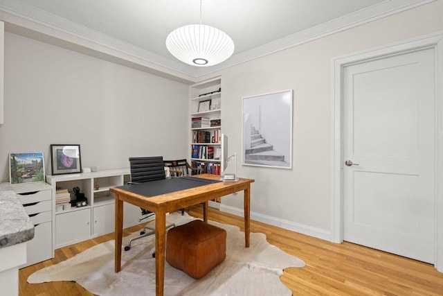 office featuring crown molding, light wood-type flooring, and baseboards
