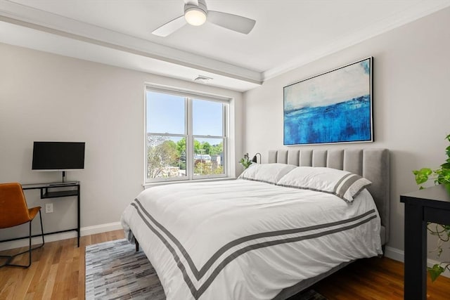 bedroom with wood finished floors, baseboards, and a ceiling fan
