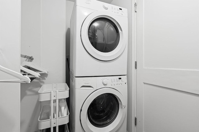 clothes washing area featuring stacked washer / drying machine