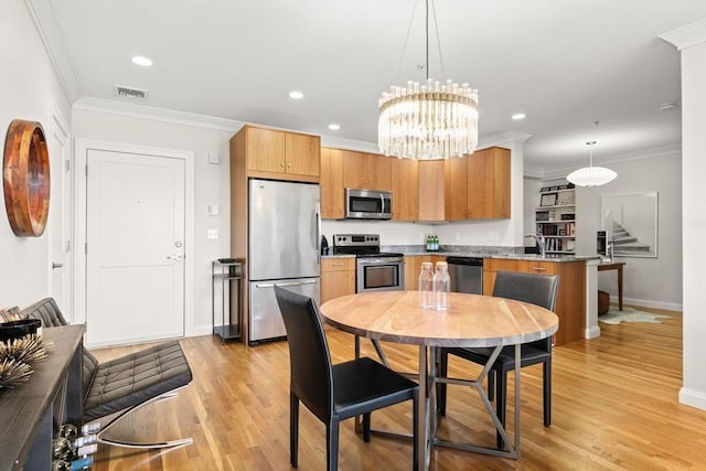 kitchen with appliances with stainless steel finishes, baseboards, ornamental molding, light wood-style flooring, and decorative light fixtures