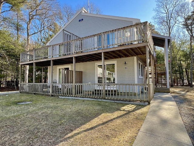 view of front of property featuring a front lawn and a wooden deck