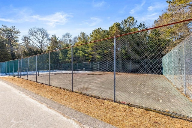 view of sport court featuring fence