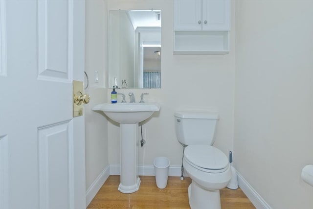 61 Providence Rd Unit 4, Grafton, MA 01519 - bathroom featuring toilet, wood finished floors, and baseboards