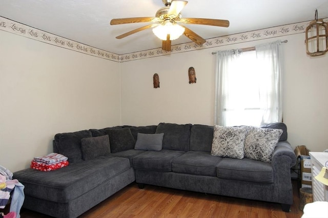 living room with plenty of natural light, ceiling fan, and wood-type flooring