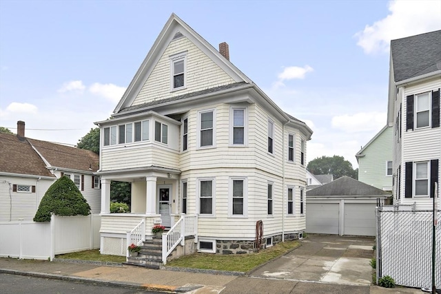 1 Elwood St, Everett, MA 02149 - view of front of house with a chimney, an outdoor structure, and a detached garage