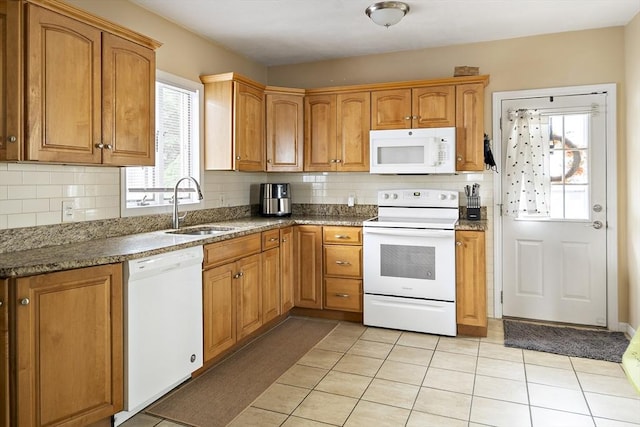 1 Elwood St, Everett, MA 02149 - kitchen with white appliances, decorative backsplash, light tile patterned floors, and brown cabinets