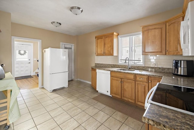 1 Elwood St, Everett, MA 02149 - kitchen with white appliances, decorative backsplash, light tile patterned floors, and dark countertops