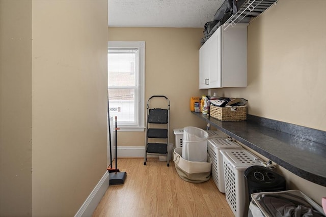 1 Elwood St, Everett, MA 02149 - laundry area with separate washer and dryer, light wood finished floors, cabinet space, and a textured ceiling