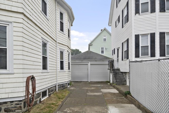1 Elwood St, Everett, MA 02149 - view of side of property featuring a garage and an outbuilding