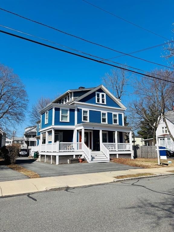 view of front of house with fence and a porch