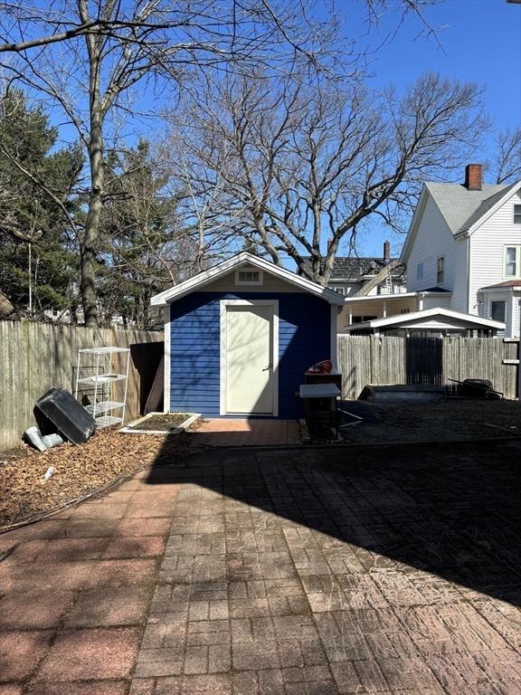 view of shed with fence