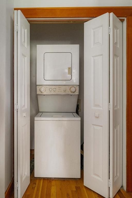 87 Bristol St Unit 3C, Cambridge, MA 02139 - laundry room with stacked washing machine and dryer and light wood finished floors
