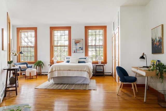 87 Bristol St Unit 3C, Cambridge, MA 02139 - bedroom featuring wood finished floors and a baseboard heating unit