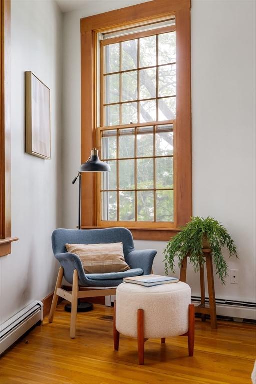 87 Bristol St Unit 3C, Cambridge, MA 02139 - living area featuring a baseboard radiator and light wood-style flooring