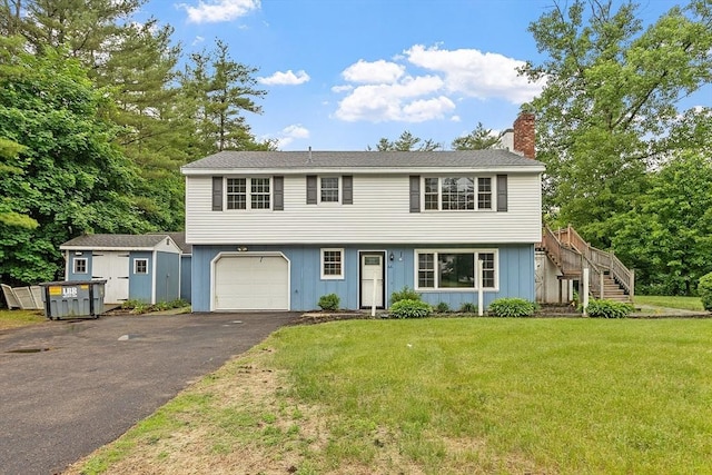 66 Park St, Pepperell, MA 01463 - colonial inspired home with a chimney, stairs, driveway, a front lawn, and board and batten siding