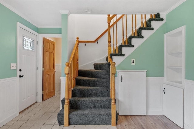 66 Park St, Pepperell, MA 01463 - entryway featuring wainscoting, stairs, crown molding, a decorative wall, and tile patterned flooring