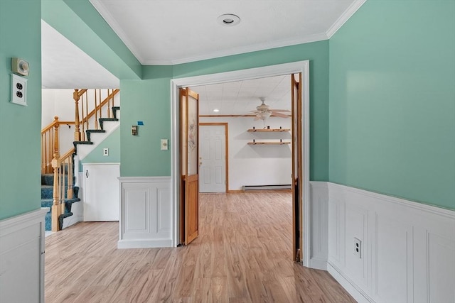 66 Park St, Pepperell, MA 01463 - corridor featuring baseboard heating, wainscoting, crown molding, light wood-type flooring, and stairs