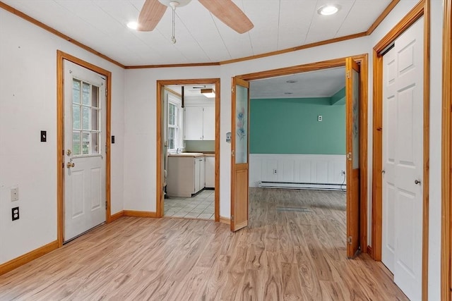66 Park St, Pepperell, MA 01463 - foyer with baseboard heating, ornamental molding, light wood-style flooring, ceiling fan, and wainscoting