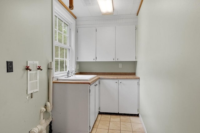 66 Park St, Pepperell, MA 01463 - washroom with cabinet space, healthy amount of natural light, light tile patterned floors, and crown molding