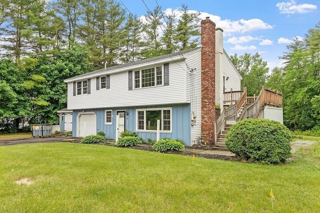 66 Park St, Pepperell, MA 01463 - view of front facade with board and batten siding, stairway, a chimney, and a front lawn