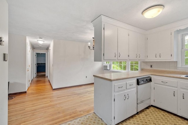 66 Park St, Pepperell, MA 01463 - kitchen featuring white dishwasher, white cabinetry, light countertops, and plenty of natural light
