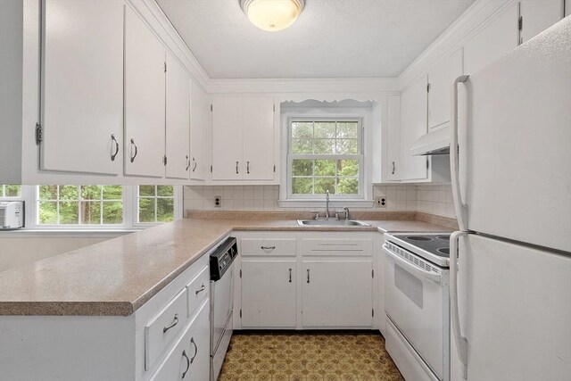 66 Park St, Pepperell, MA 01463 - kitchen with white appliances, under cabinet range hood, white cabinetry, and decorative backsplash