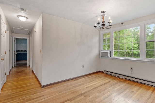 66 Park St, Pepperell, MA 01463 - spare room with attic access, light wood finished floors, a smoke detector, a baseboard heating unit, and plenty of natural light