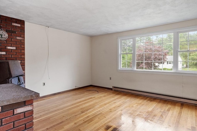 66 Park St, Pepperell, MA 01463 - unfurnished room featuring a baseboard heating unit and light wood-style floors