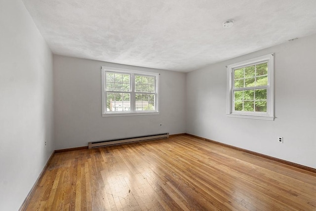 66 Park St, Pepperell, MA 01463 - empty room with baseboard heating, a smoke detector, and wood-type flooring