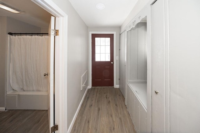 mudroom with visible vents, baseboards, and wood finished floors