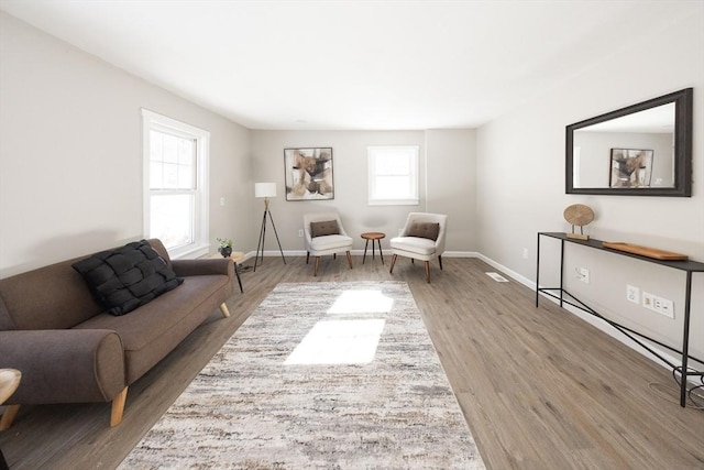 sitting room featuring baseboards and wood finished floors