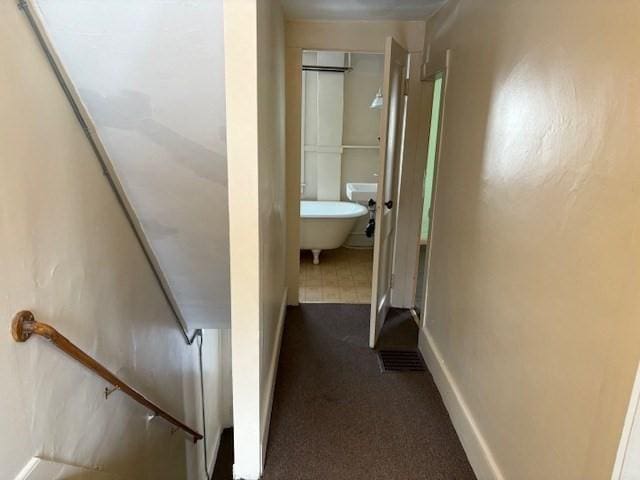 corridor with dark colored carpet