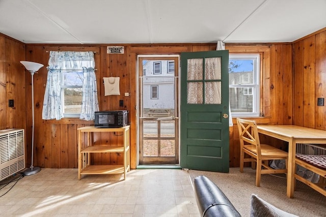 entryway featuring wooden walls