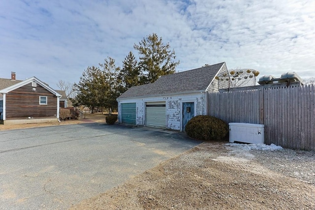 exterior space featuring driveway and fence