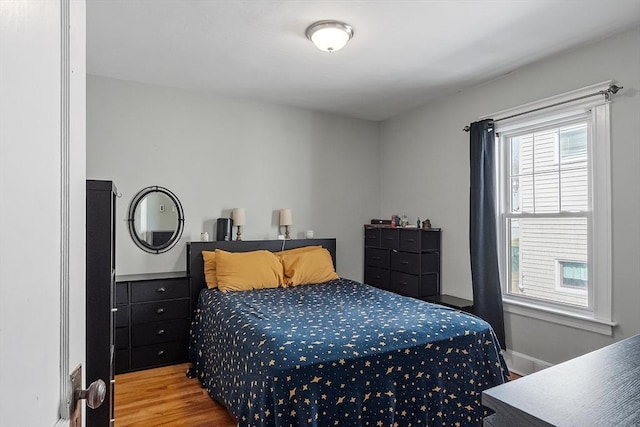 bedroom with baseboards and wood finished floors