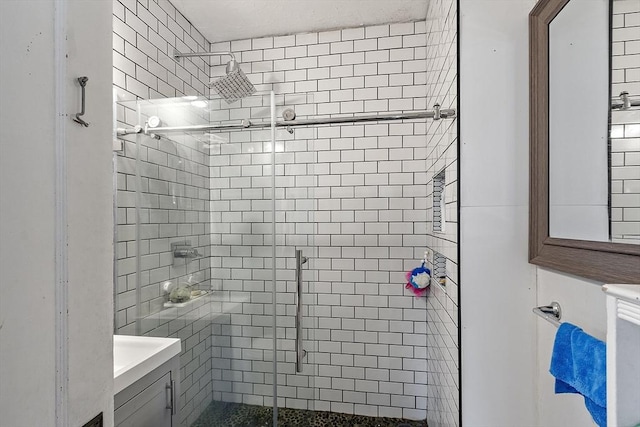 full bath with a stall shower and vanity