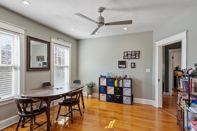 dining area featuring recessed lighting, light wood-style flooring, a ceiling fan, and baseboards