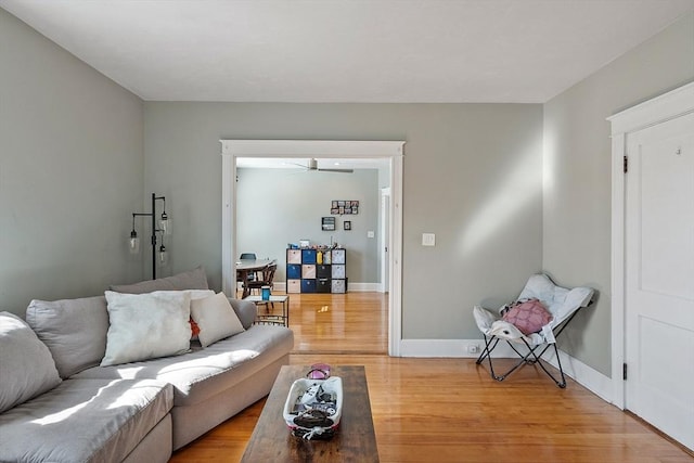 living area with light wood-style floors and baseboards