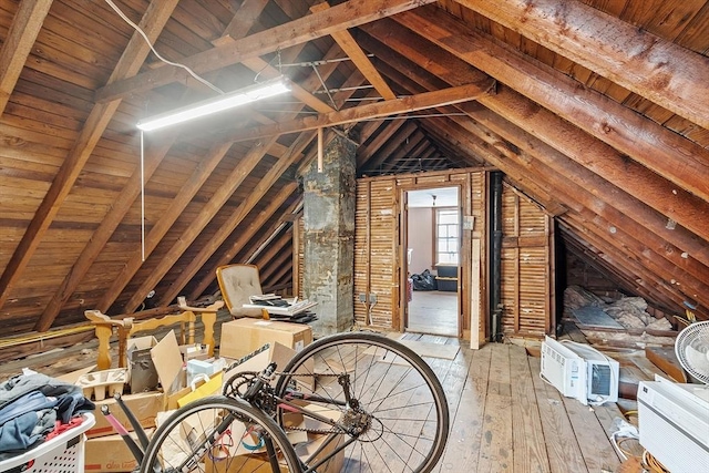 attic featuring an AC wall unit