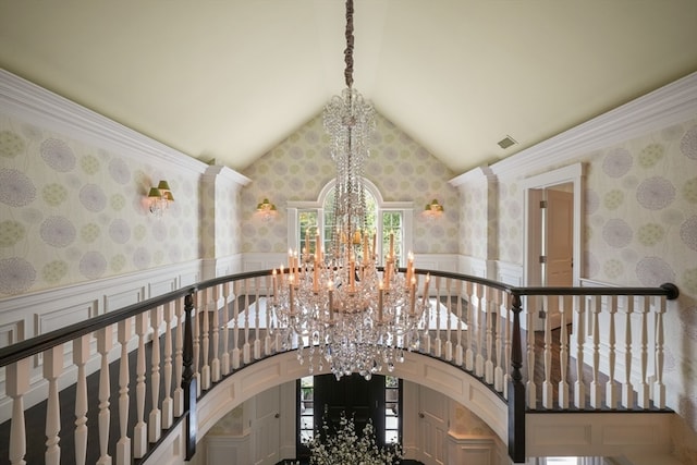 staircase featuring high vaulted ceiling and an inviting chandelier