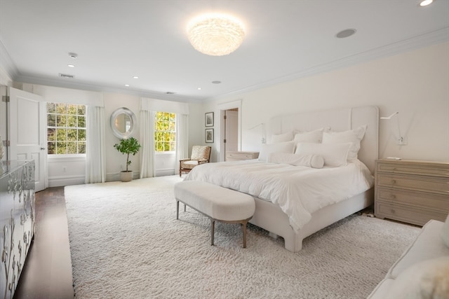 bedroom with ornamental molding and hardwood / wood-style flooring