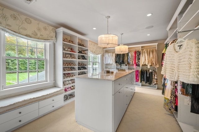 walk in closet featuring light colored carpet