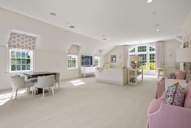 carpeted bedroom featuring lofted ceiling and multiple windows