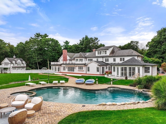 back of property with a patio area and a lawn